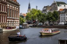 Passengers ride on a tour boat along a canal in Amsterdam on June 17, 2022, as a heatwave spreads across Europe. - - Netherlands OUT (Photo by Remko de Waal / ANP / AFP) / Netherlands OUT (Photo by REMKO DE WAAL/ANP/AFP via Getty Images)